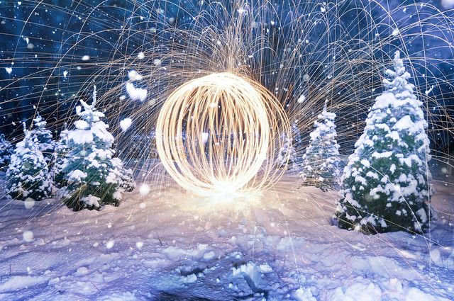 Steel wool long exposure light painting with on-camera flash freezing snow flakes falling