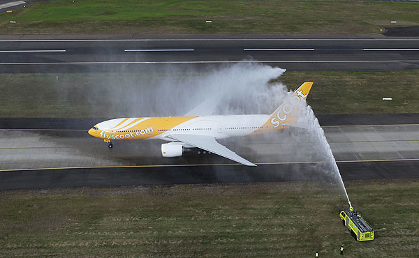 Inaugural Scoot commercial plane to land in Sydney,  greeted by fire-engine trucks hosing if off as a grand welcome last year (photo by JAMES MORGAN)