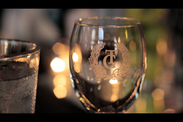 The wedding logo etched on a wine glass