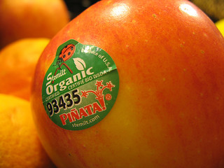 a photo of a red apple with an organic sticker on it