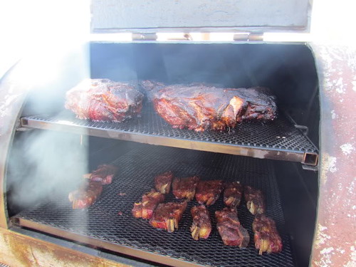 Pork butts and short ribs cooking to perfection. For the ultimate barbecue master, using a smoker is the only way to go.  Photo courtesy Markus McPhail, AMS Livestock and Seed Program