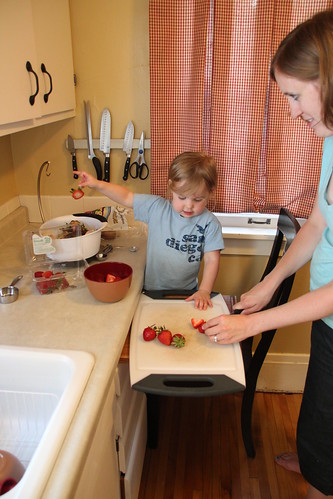 Annie helping cut strawberries