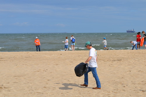 U.S. Scott Rigell combs the beach at First Landing State Park's Clean the Bay Day activities