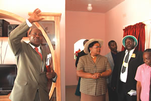 Chief Kasekete’s brother Mr Wilson Mutinhima shows Acting President Joice Mujuru the house Prophet Emmanuel Makandiwa built for the chief in Muzarabani on June 1, 2012. Looking on is the chief and other guests. by Pan-African News Wire File Photos