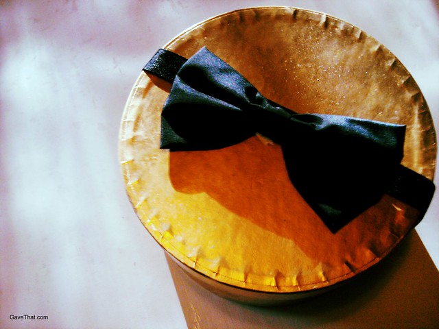 Gift bow on hat box using Grosgrain ribbon and a vintage bow tie which can later be turned into a prim belt