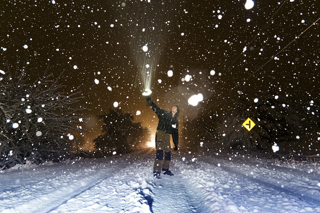 Long exposure showing motion of snow falling lit by flashlight AND on-camera flash freezing motion of snow falling at night 