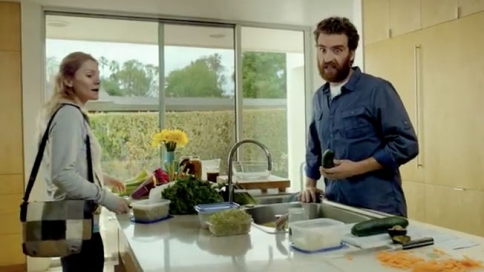 screen shot from the Sunrun ad campaign. A white man and woman are in their kitchen together