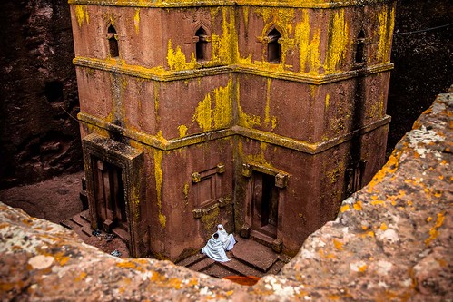 pilgrims prays in the church of St. George in the shape of a cross carved into the rock, Lalibela, Ethiopia