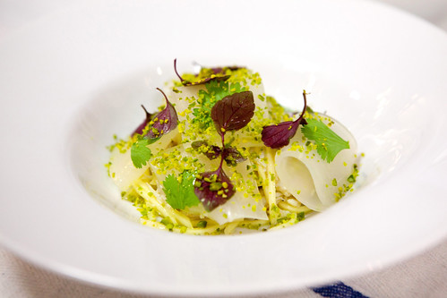 The plated Peekytoe Crab Salad with green mango, pickled daikon, toasted pistachio, pistachio with tarragon dressing