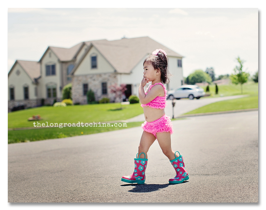 FIngers in mouth walking across the driveway in her ruffles and boots BLOG