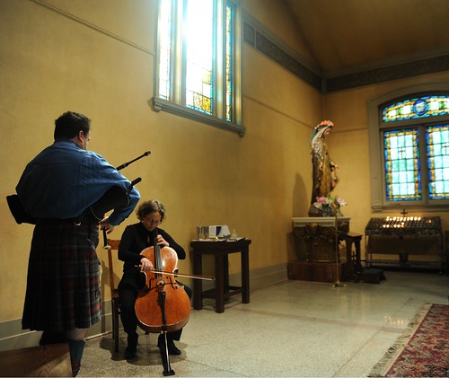 Bagpipe player and cellist, statue of Mary, votive candles, stained windows, rug, St. James Cathedral, First Hill, Seattle, Washington, USA by Wonderlane