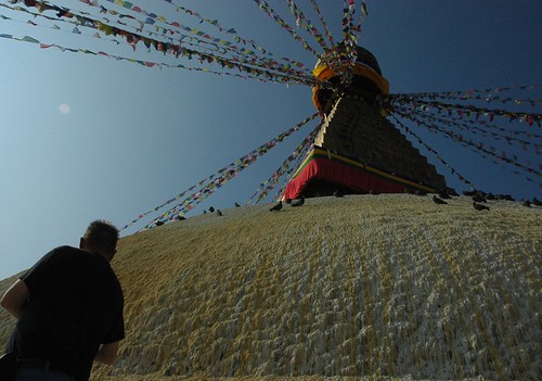 Prayers at the dome of Bodha's great wish-fulfilling stupa, pigeons, whitewash, prayer flags, Bodha, Kathmandu, Nepal by Wonderlane