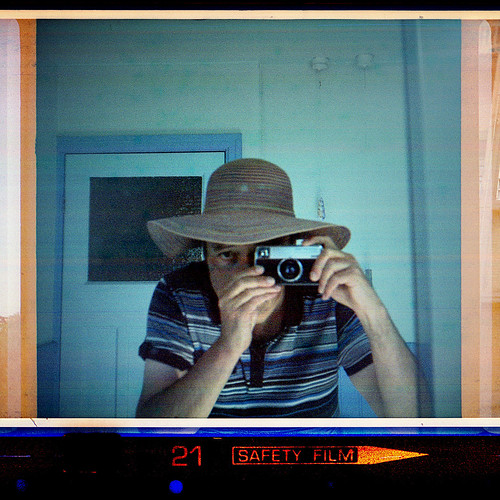 reflected self-portrait with Kodak Instamatic 233-X and floppy hat by pho-Tony
