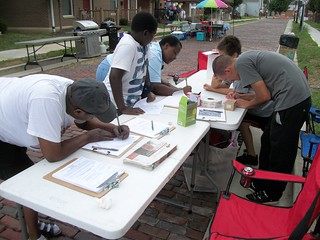 Member Kyle Randall signing in people to Liberty Row Block Party and helping register voters.  