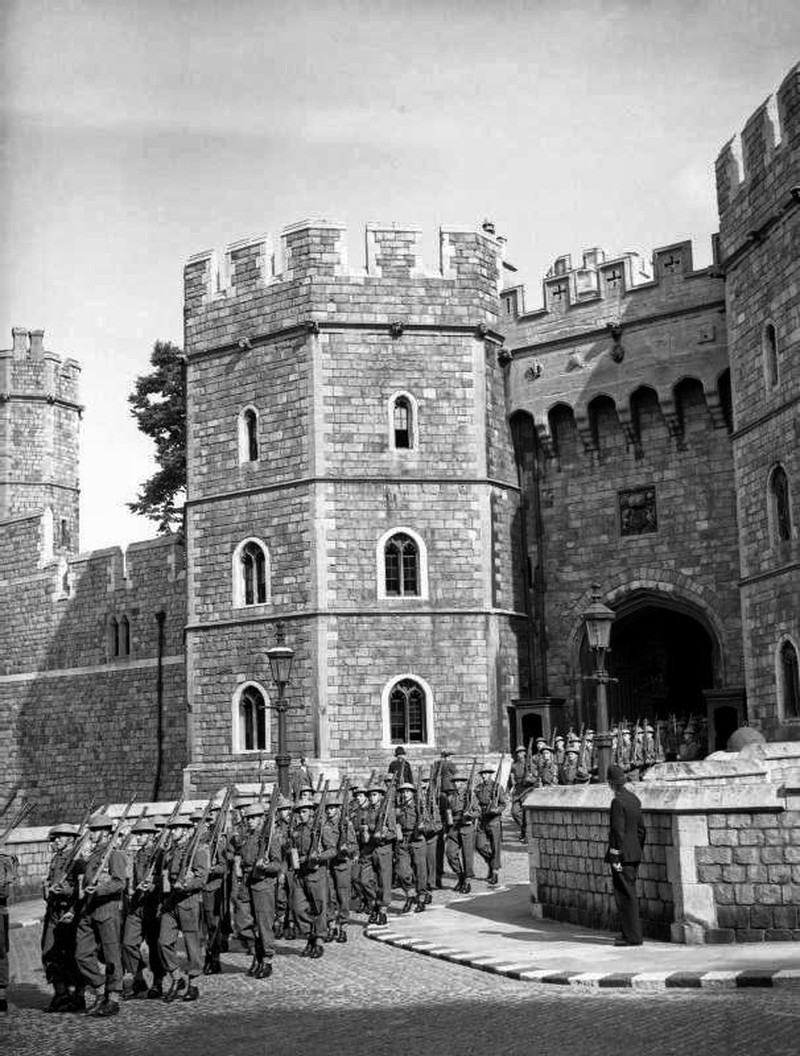 The Castle Guard, formed from members of the training battalion, Grenadier Guards, leaving the main entrance of Windsor Castle on the way to Victoria Barracks in Windsor, 30 June 1940
