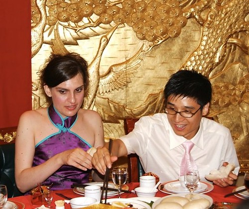 Eating dinner at the family table at my Chinese wedding ceremony while I 