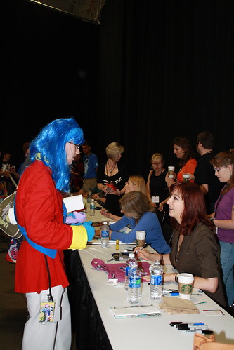 another male fan dressed as a different pony talks to Lauren Faust