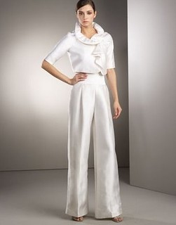 a woman in a white pants suit