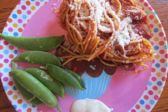 Addy eats: spaghetti, parmesan cheese, sugar snap peas, and a smidge of ranch dressing