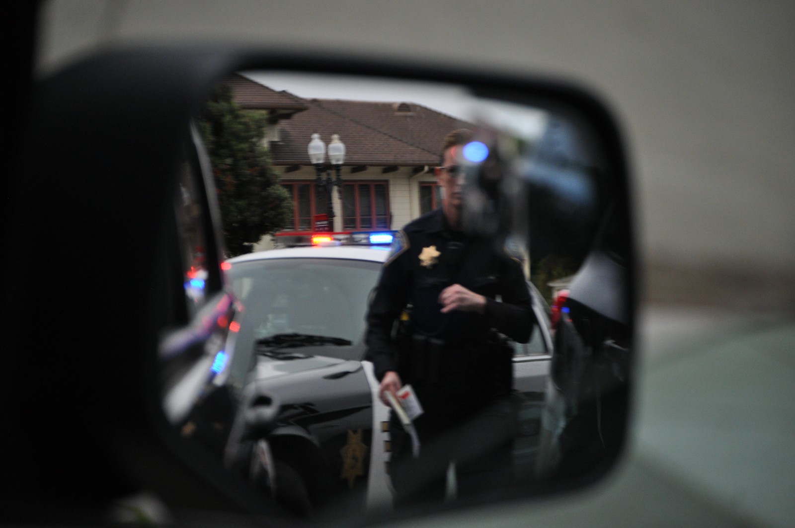 Police officer in side view mirror
