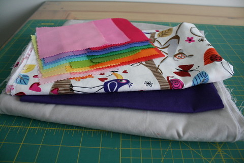 Stacks of fabrics for projects on the list