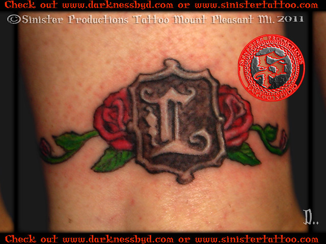 Sinister Productions Tattoo Studio The royal letter L surrounded by 2