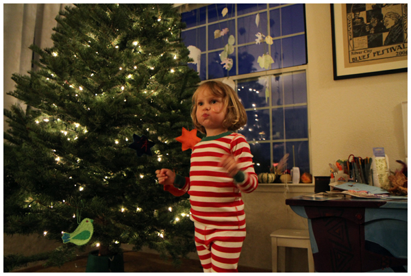 Dancing around the Christmas tree in her new pajamas