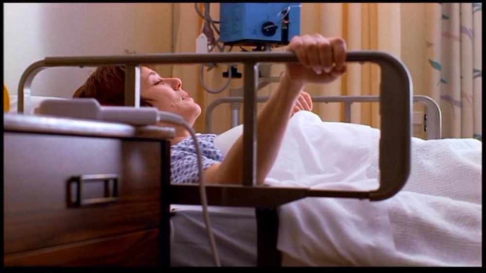 May-Alice, played by Mary McDonnell, in a hospital bed