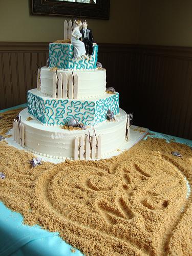The striking blue lace details on this beach theme cake really make the cake