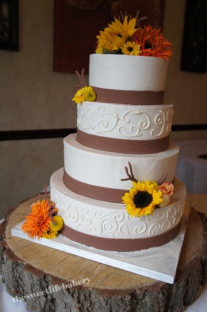 This fall themed wedding cake has a simple fondant band with a few fondant 