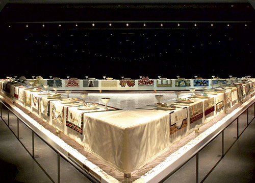 Judy Chicago's Dinner Party, a table in a large gallery space set with many different place settings