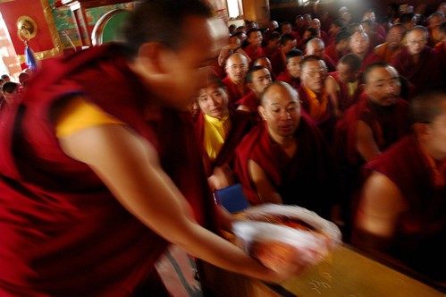 A monk offers senior Tibetan Lamas offered hundreds of cords for blessing, Sakya Lamdre, Tharlam Monastery of Tibetan Buddhism, Boudha, Kathmandu, Nepal by Wonderlane