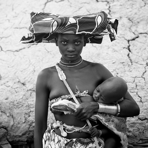 Mucubal Woman Holding Her Baby, Virie Area, Angola by Eric Lafforgue
