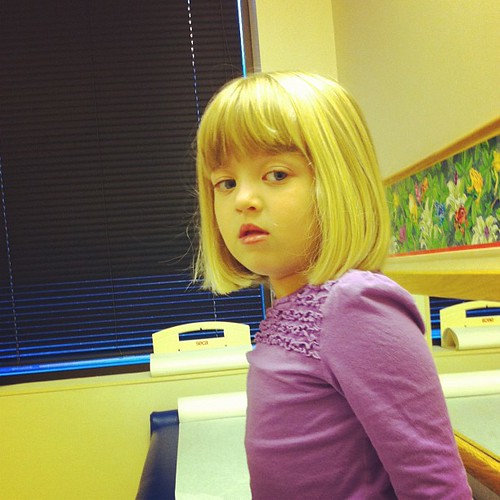 Poor feverish girl at the doctor. Not feeling good. Temp is 101.3.