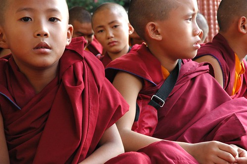 Young boys, Tibetan Buddhist monks, wearing traditional maroon / red robes, Sakya Lamdre, Tharlam Monastery Stage, Boudha, Kathmandu, Nepal by Wonderlane