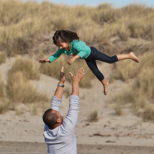 Love and Trust - Father tosses his confident daughter into to air accompanied by screams of delight.
