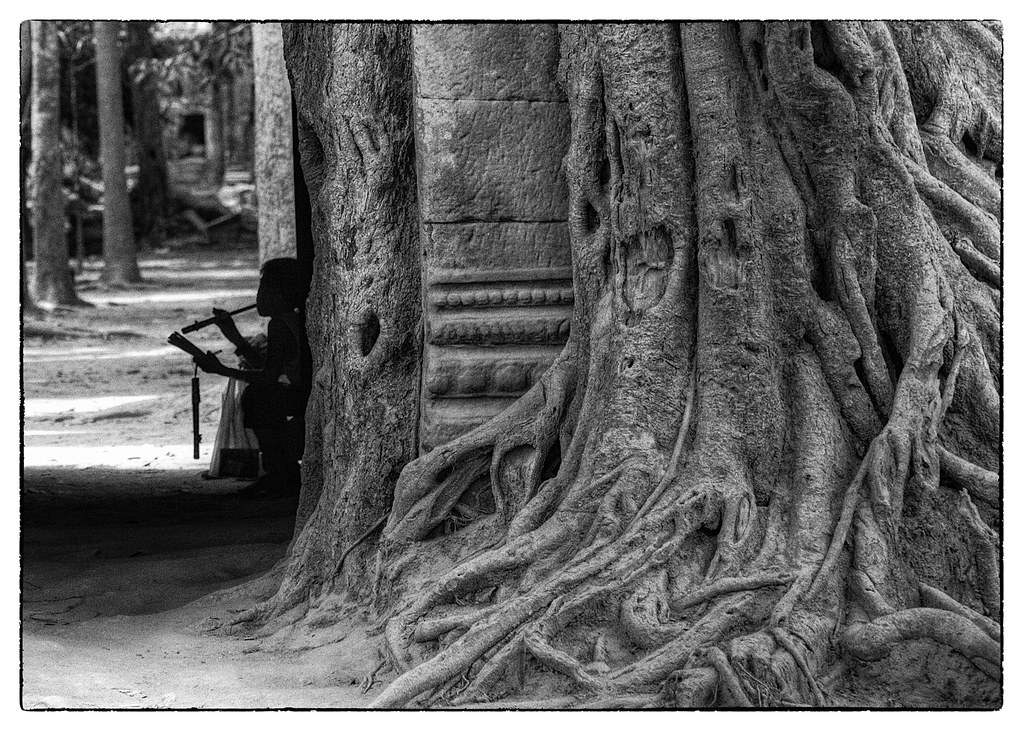 Taking a break from selling flutes, Angkor Wat, Cambodia
