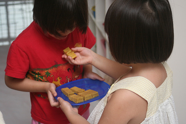 Jolie giving a piece of kueh lapis to Nadine