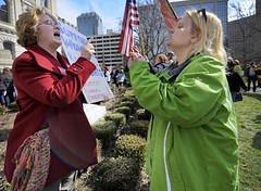 two white women arguing at a rally