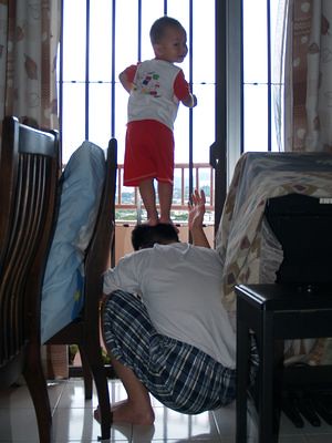 Justin standing on Daddy's head