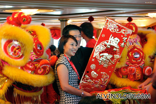 Two Star Cruises senior staff, Michael and Sandy unrolling a Chun Lian scroll