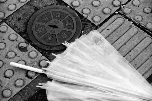 manhole and a broken umbrella