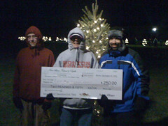 Portsmouth's East Bay Martial Arts with winners' check at Newport Festival of Lights