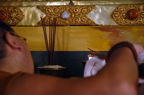 Chopon making an incense offering on a Tibetan Buddhist shrine, mala, semi-precious stones set in ornate gold and silver reliquary monument, Sakya Lamdre, Tharlam Monastery, Bodha, Kathmandu, Nepal by Wonderlane