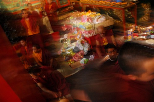 Rush of offerings, Tibetan Buddhist monks, shrine stacked with offerings, conclusion, Sakya Lamdre, Tharlam Monastery of Tibetan Buddhism, Boudha, Kathmandu, Nepal by Wonderlane