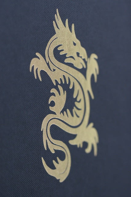 This gold dragon highlighting the Dragon Tattoo motif is imprinted on the 