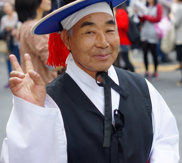 Korean man wearing traditional clothes smiles, image from flickr user Nomadic Samuel