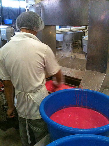 The steamed layered kueh goes around a conveyor belt