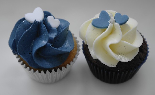 Cute little mini cupcakes in navy blue and ivory for a wedding tower