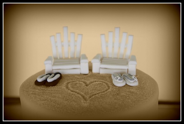 Simple beach themed wedding cakeeverything including the deck chairs are 